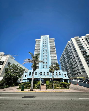 Front view of a multi-story residential building with balconies.
