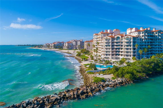 Panoramic view of beachfront apartment buildings overlooking the ocean.