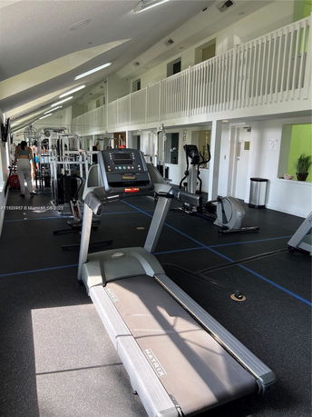Interior view of a gym with various exercise equipment and a treadmill.
