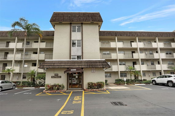 Front view of a multi-story apartment building with balconies.