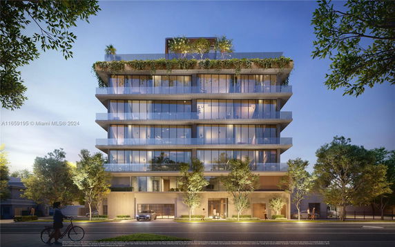 Front view of a modern multi-story building with glass balconies and greenery on the rooftop.