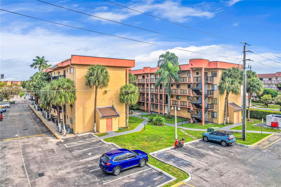 Front view of multi-story apartment buildings with external staircases.