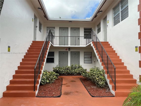 Two-story building with exterior staircases leading to the second floor.