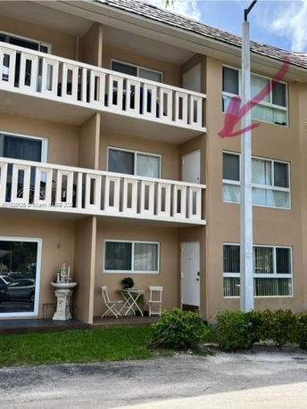 Front view of a multi-story building with balconies.