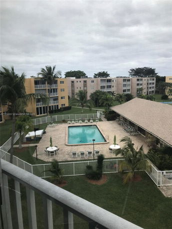 Outdoor swimming pool area surrounded by residential buildings.