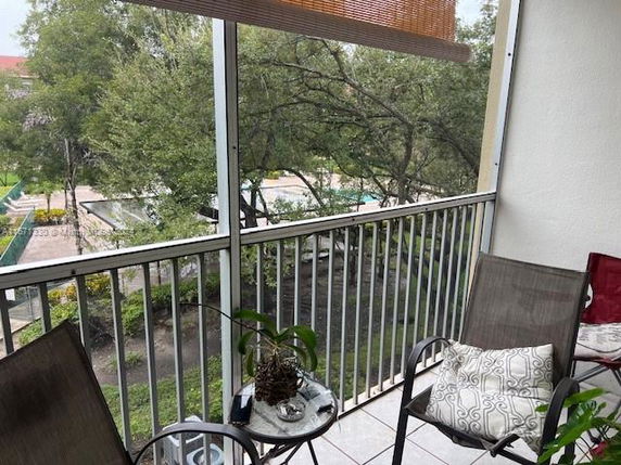 View from a balcony overlooking trees and outdoor surroundings.