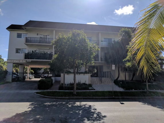 Front view of a multi-story residential building with balconies.