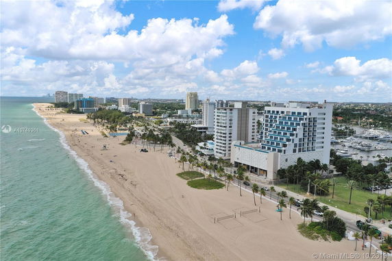 Aerial view of beachside buildings and coastline.