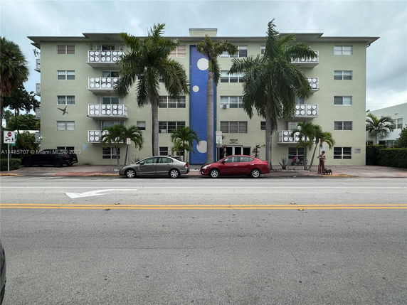 Front view of a mid-rise apartment building with balconies.