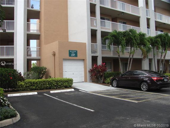 Outdoor parking area in front of a multi-story building.