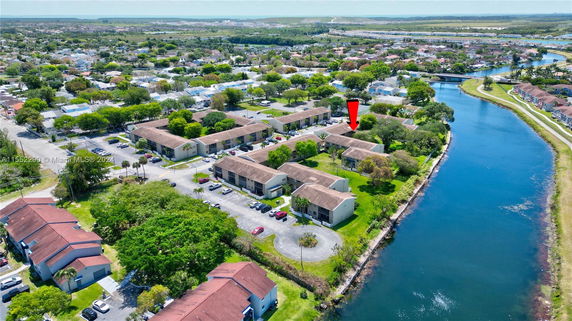 Aerial view of a residential area with multiple apartment buildings near a canal.