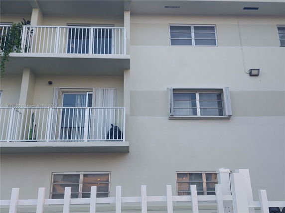 Front view of a building with balconies and windows.