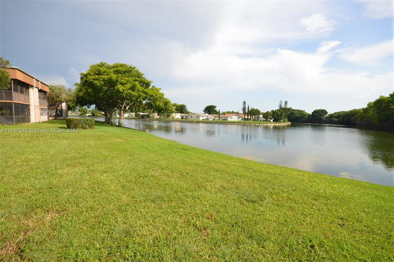 Lake view with houses and trees surrounding the water.