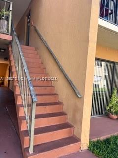 Exterior view of a building with stairs leading to an upper level.