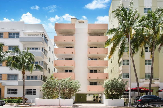 Front view of a multi-story apartment building with balconies.