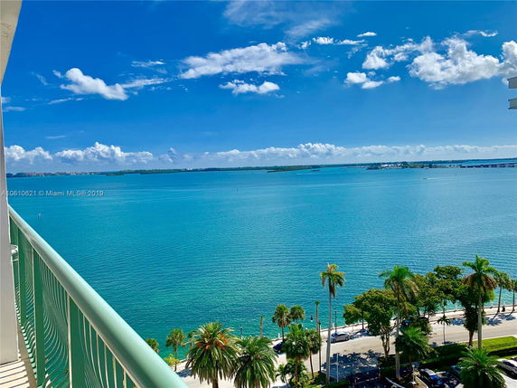 Panoramic view of a waterfront area with blue skies and scattered clouds.