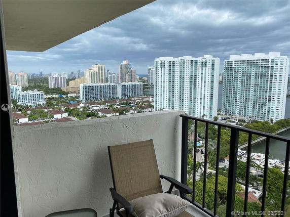 Panoramic view of high-rise buildings from a balcony.