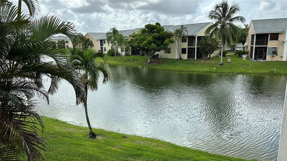 A view of water, greenery, and residential buildings.