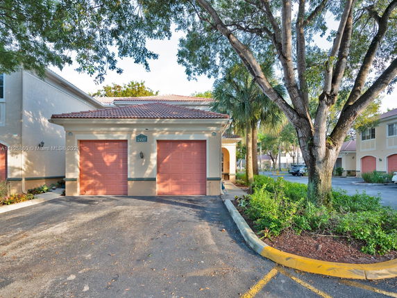Front view of a house with a double garage and tile roof.
