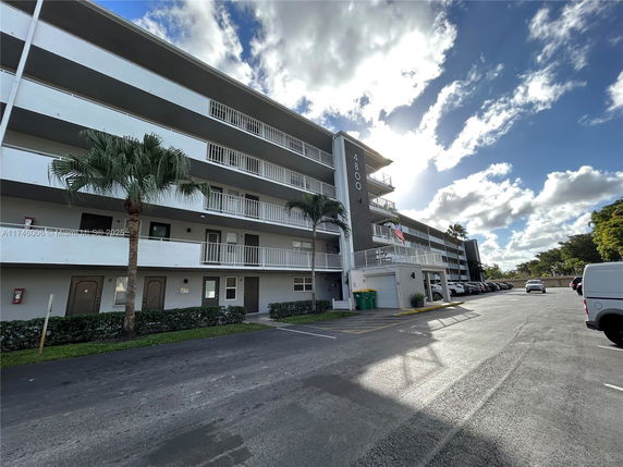 Front view of a multi-story apartment building with balconies.