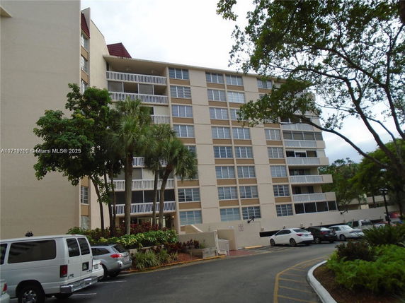 Front view of a multi-story residential building with balconies.