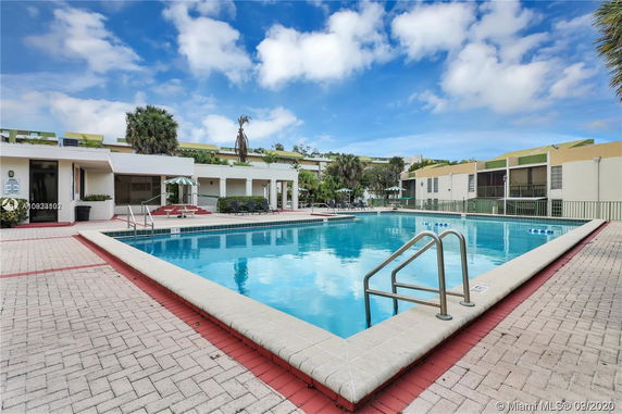 Outdoor swimming pool in front of a residential building.