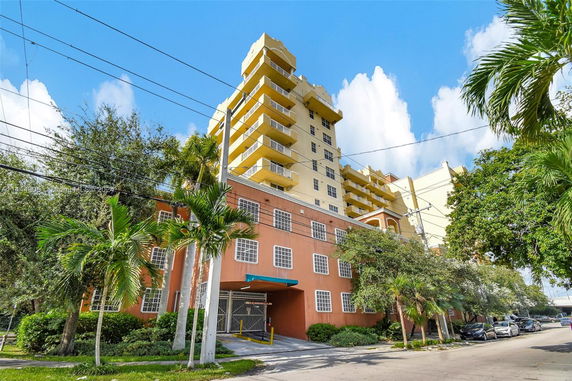 Front view of a multi-story residential building with balconies.