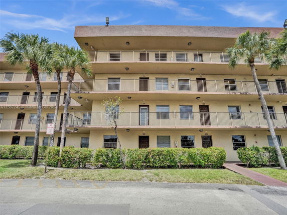 Front view of a multi-story residential building with balconies.