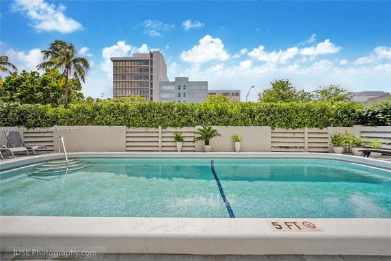 Outdoor swimming pool with views of surrounding buildings.