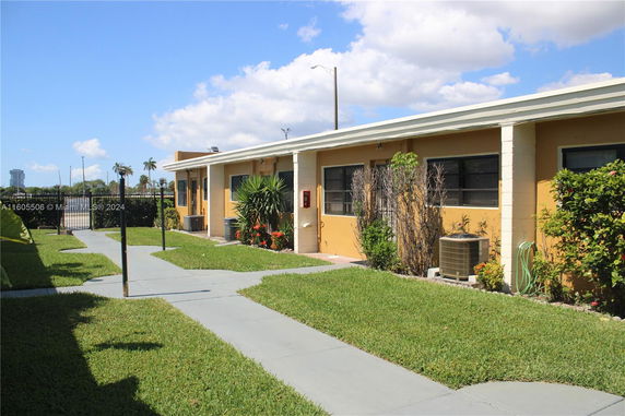 Side view of a single-story building with multiple windows.