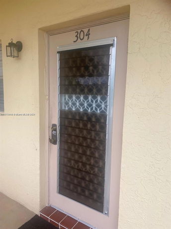 Front view of a building door with the number 304.