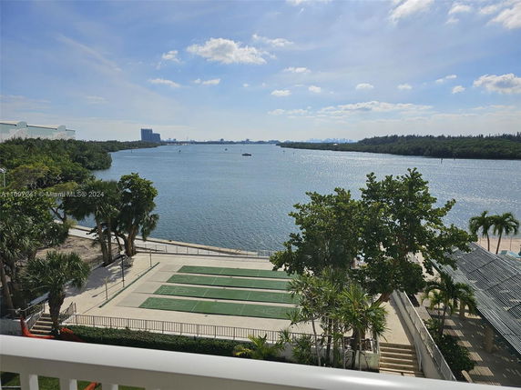 Panoramic view of a waterfront area with a river and surrounding greenery.