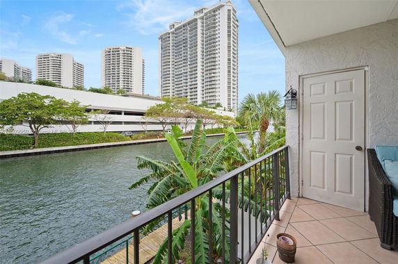 Balcony view overlooking a canal and surrounding high-rise buildings.
