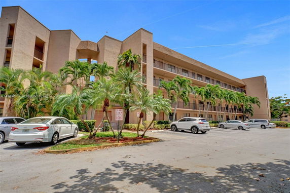 Front view of a multi-story residential building with balconies.