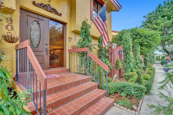 Front view of a house with a decorated entryway and steps.