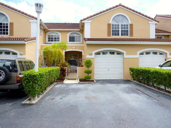 Front view of a two-story house with double garage and driveway.