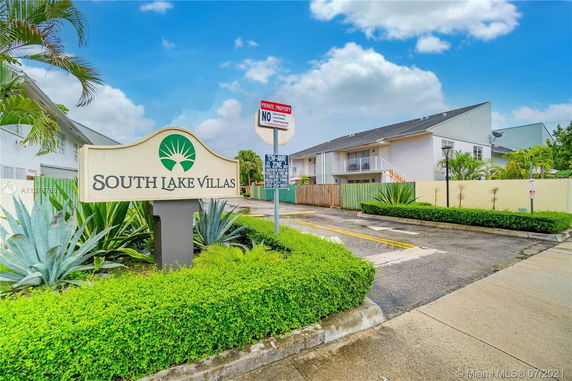 Front view of a two-story villa complex with a South Lake Villas sign.