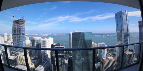 Panoramic view of skyscrapers and a body of water in the background.