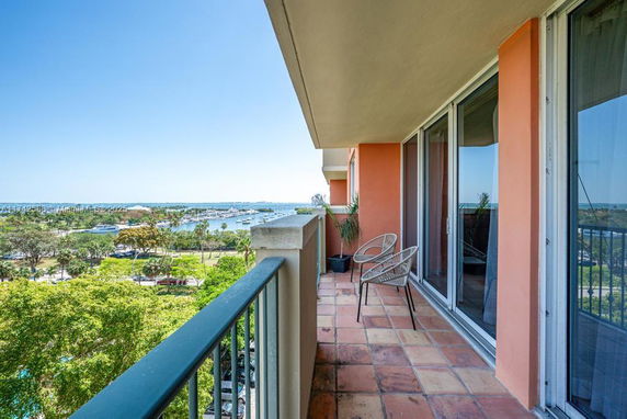 Elevated balcony with a view of surrounding marina and greenery.