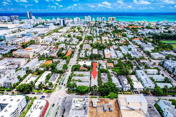 Aerial panoramic view of a coastal cityscape with numerous buildings and a visible coastline.