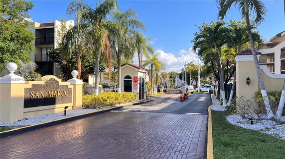 Entrance view of a residential complex with a sign labeled 'San Marco'.
