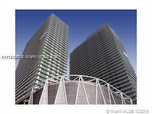 Front view of two modern high-rise buildings with glass facades.