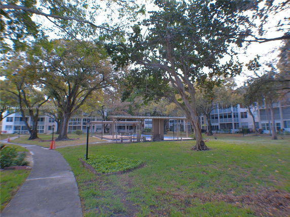 View of surrounding areas with trees and multi-story buildings.
