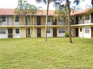 Exterior view of a two-story residential building with a courtyard.