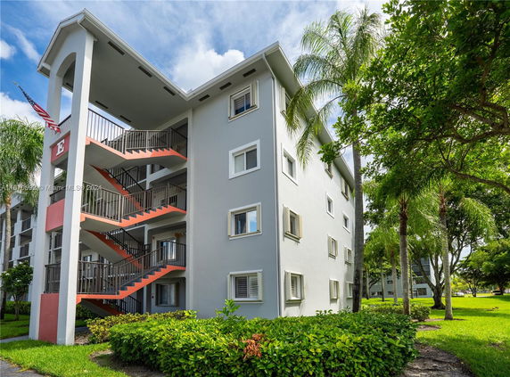 Front view of a multi-story residential building with exterior staircases.