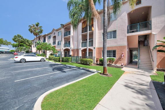 Front view of a multi-story apartment building with balconies.