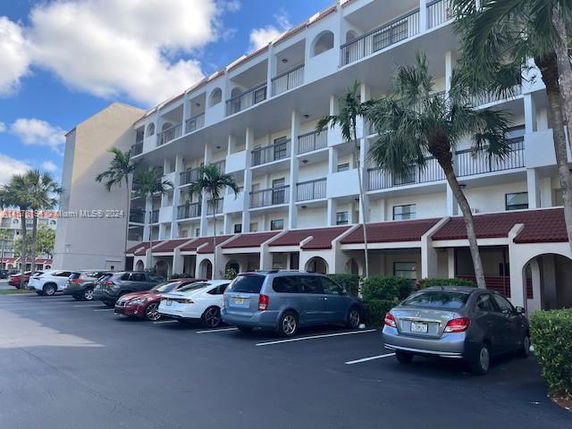 Outdoor parking area in front of a multi-story building.