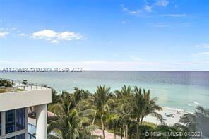 View of the ocean and palm trees from a building.