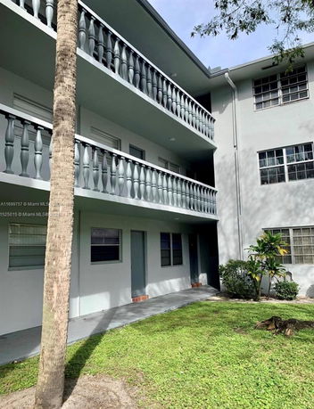 Front view of a multi-story building with balconies.