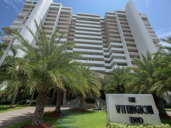 Front view of a multi-story residential building with balconies.